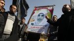Palestinians hold a picture of female prisoner Hana Shalabi outside the United Nations office in Gaza City on February 28, 2012.