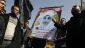 Palestinians hold a picture of female prisoner Hana Shalabi outside the United Nations office in Gaza City on February 28, 2012.
